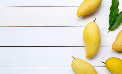 Tropical fruit, Mango on white wooden background.