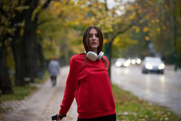 Portrait of running woman after jogging in the park on autumn seasson. Female fitness model...