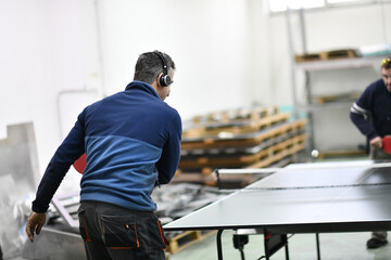 industry workers table tennis game and relaxing in their free time