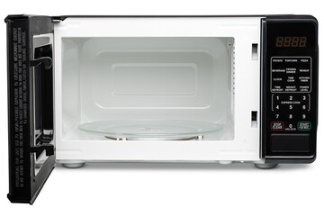 Obraz premium Microwave oven. Black microwave oven for warming food, drink, cooking lunch, defrost meat, cook meal. Electrical kitchen appliances. New equipment for house. Isolated Background