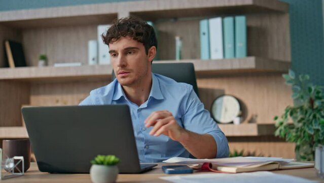 Company executive reading bad news in office. Angry man looking computer error