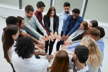 Obraz premium Narrow banner of multiracial people stack hands motivated for shared business success or goal achievement.