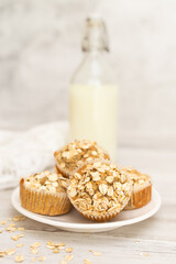 Cereal, oatmeal, banana muffins on white wooden table. Homemade cupcake.  