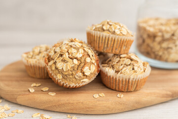 Cereal, oatmeal, banana muffins on white wooden table. Homemade cupcake.  