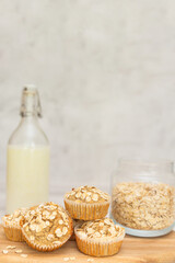 Cereal, oatmeal, banana muffins on white wooden table. Homemade cupcake.  