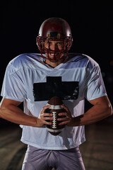 American Football Field: Lonely Athlete Warrior Standing on a Field Holds his Helmet and Ready to...