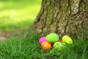 Easter celebration. Painted eggs on green grass, space for text