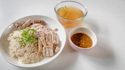 Hainanese Chicken Rice or Chicken Soup Rice - Asian Feet Style thaifood concept on
white background.  