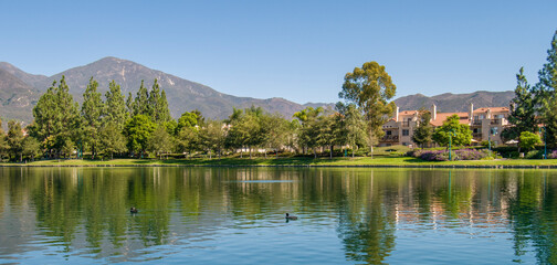City of Rancho Santa Margarita, Orange County USA, view of the lake and mountains near the trees 