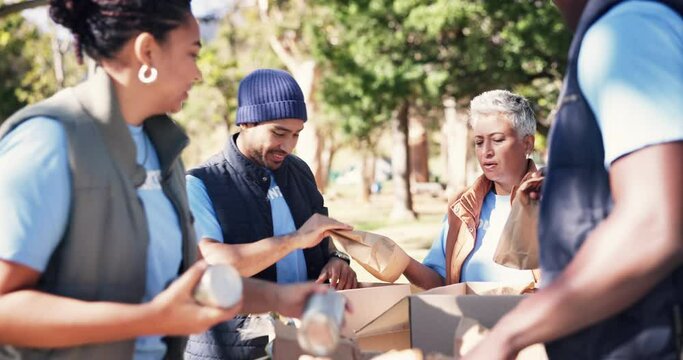 Volunteers, food box and donation in outdoors, help and community service for social responsibility. People, donation and grocery bags for society project, non profit and teamwork for accountability
