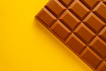 Detail of chocolate bar isolated on yellow background