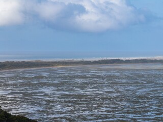 The Farewell Spit at the top of the South Island at low tide at sunset. Puponga, Collingwood, Tasman, New Zealand.