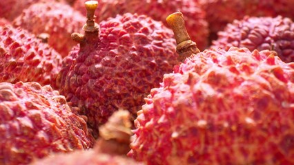 Explore the intricate beauty of lychee skin up close, as the camera unveils its textured surface....