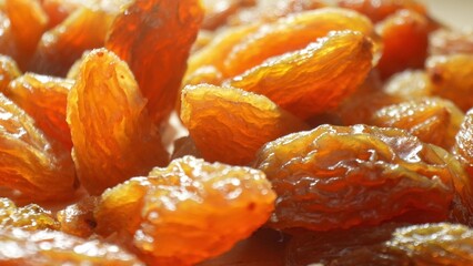 Explore the intricate texture of green raisins, a symphony of wrinkles and golden-brown hues echoing their sun-soaked journey. Sweetness captured in every detail.
