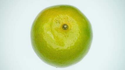 The ripe orange boasts a golden-hued rind, adorned with delicate pores, while its fresh stem...