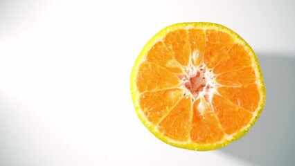 Bursting with vitality, the close-up captures the glistening flesh of a freshly cut half orange, exuding freshness and allure through its radiant orange hues. Orange background. 
