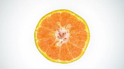 Radiant and succulent, a close-up of a freshly cut half orange gleams with juicy brilliance, its vibrant segments inviting a refreshing indulgence. Orange background. 
