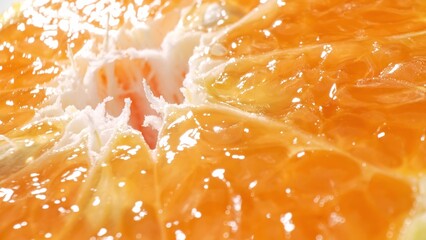 Dive into the tantalizing sight of a halved orange, its juicy segments glistening with vibrant...