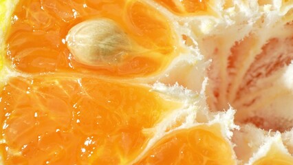 An intimate macro of a halved orange reveals its intricate segments, vibrant hues, and glistening...