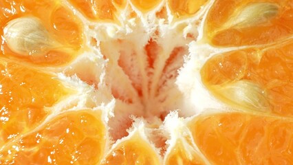 With a golden glow, the surface of this juicy orange half shimmers, each segment bursting with...