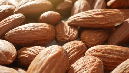 Zoom in on whole almonds, their rustic brown shells snugly encasing the creamy kernels. Each shell,...