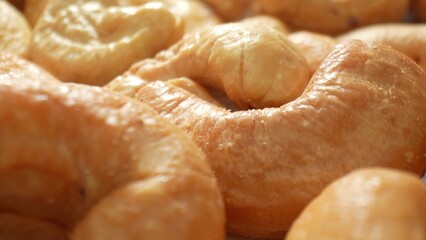 Indulge in the allure of golden-brown roasted cashews, their surface a testament to perfection....