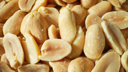 Delve into the macrocosm of split roasted peanuts, adorned in a uniform golden-brown tone. The subtle sheen hints at their perfectly roasted essence, enticing the senses.
