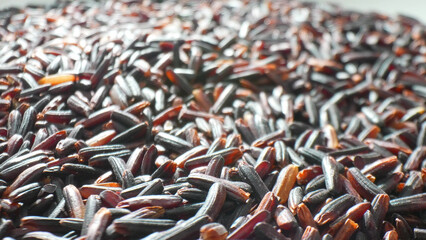 Behold Riceberry rice: an opulent tapestry of dark grains, reminiscent of precious black pearls. Its hues dance between deep purples and subtle reds, a testament to nature's artistry and bounty.
