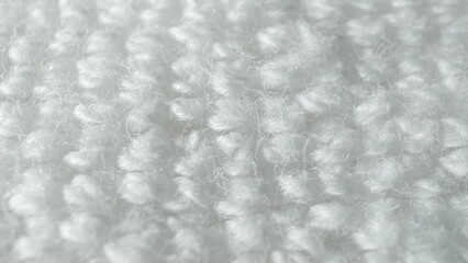 Up close, the white fabric captivates with its soft, fluffy fibers. Each looped yarn contributes to...
