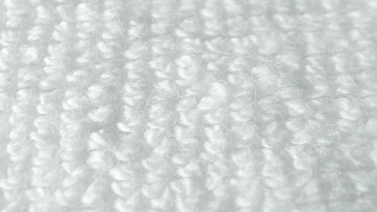 A captivating close-up reveals a pristine white fabric, its fibers soft and fluffy, boasting a...