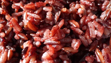 A mesmerizing close-up captures the striking contrast between Riceberry's deep purple grains and the delicate, pale hues of Jasmine rice, forming a captivating blend of textures and colors.
