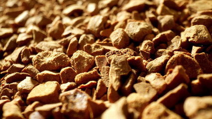 Illuminated by a tender glow, the freeze-dried coffee granules reveal their intricate, porous...