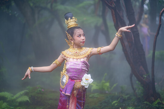 Cute girl in Kinnaree dress. The Kinnaree is significant character in Thai literature, a half-human, half-bird creature, a beautiful woman with wings to fly, resides in the Himavanta forest