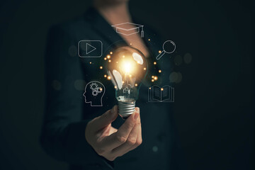 Glowing light bulb in hand, idea search concept Creativity from information trade in the internet...