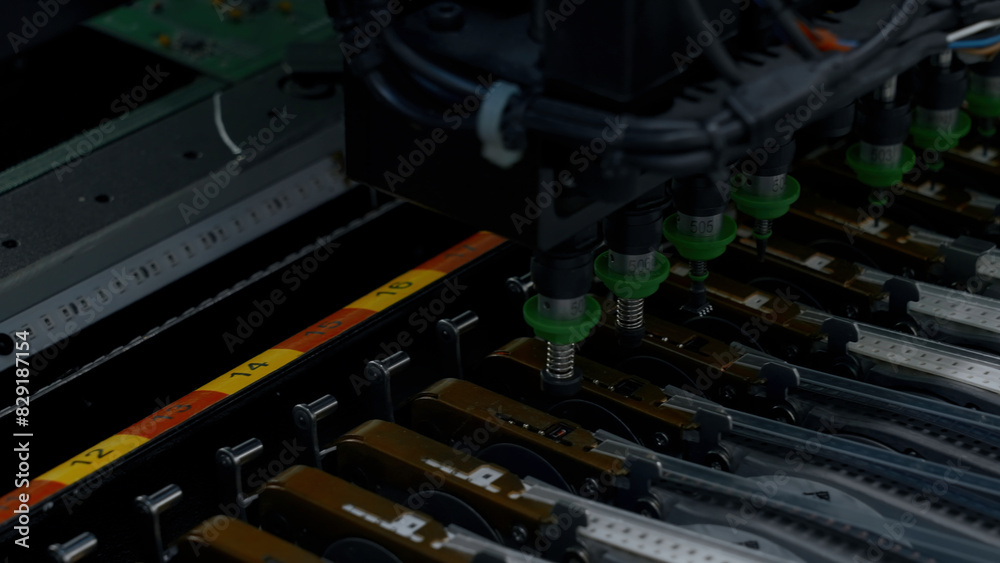 Poster close up of details of automatic smd pick and place machine during work. creative. assembly of compu