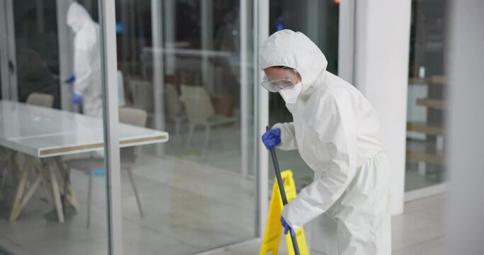 Professional, office and cleaning service and disinfect, mopping and sterilization for health care. Germ, protection and virus with safety suit for chemical exposure, fumigation team and hygiene mask