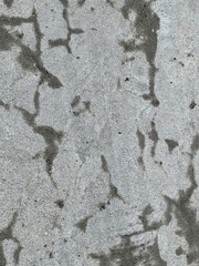 a photography of a concrete surface with a lot of cracks.