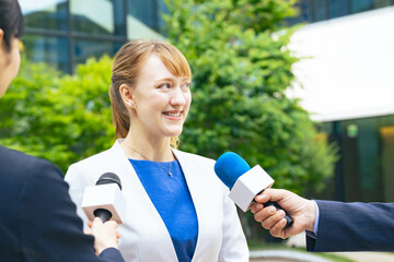 A white woman being interviewed by the press