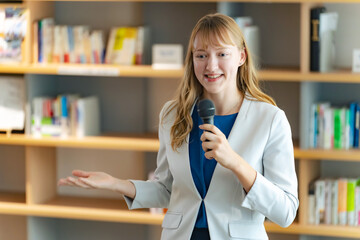 Caucasian woman giving a speech in the lobby