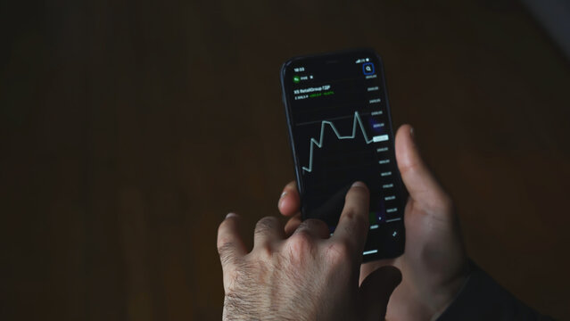 Crypto currency trading chart mobile phone. Media. Close-up of man looking at currency chart on his phone. Cryptocurrency chart on stock exchange from your phone