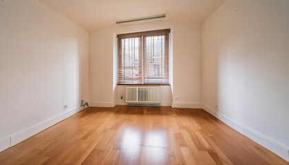 An unfurnished room featuring oak parquet flooring and a barred aluminum window