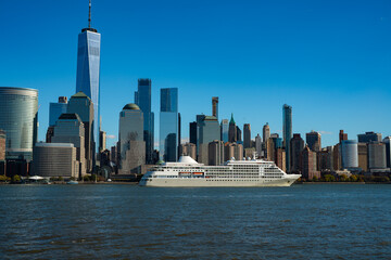 Fototapeta premium The city skyline of New York City in USA, United States. Blue sky day with iconic buildings. New York City NYC Manhattan Downtown Skyline, viewed from Jersey City, USA.
