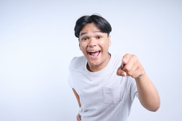 Potrait Of Excited Young Asian Guy Pointing At You Isolated On White Background