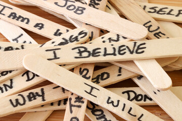 Positive Affirmations Written On Wooden Popsicle Sticks With Wood Background