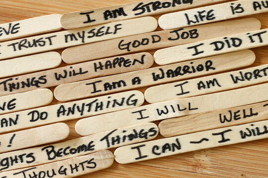 Positive Affirmations Written On Wooden Popsicle Sticks With Wood Background