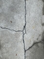 a photography of a fire hydrant on a sidewalk with cracks.