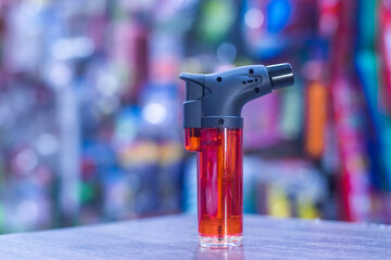 Red flame lighter, black head, placed in the middle of the store. There are many items available...