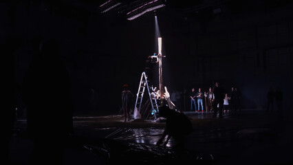 Assembling stage decorations for the performance. Media. Making a wooden construction in a dark...