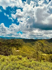 Obraz premium Gorgeous stock image of a foggy, blue sky over a landscape of mountains and forests