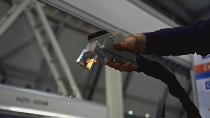 Laser removes rust on metal. Media. Hand gun with laser removes rust on metal. Laser with beam...
